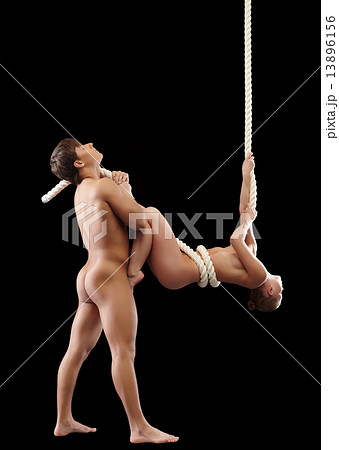 Enchanted nude man cuddles sexy girl hangs on rope Enchanted nude man cuddles sexy girl hangs on rope 13896156