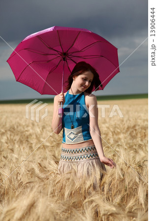 Girl with umbrella at field. 13906444