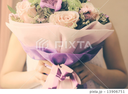 Bride or bridemaid with bouquet of flower, retro filter effect Bride or bridemaid with bouquet of flower, retro filter effect 13906751