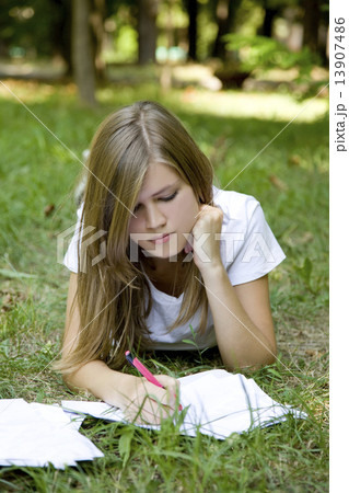 Teen girl with book in the park. 13907486