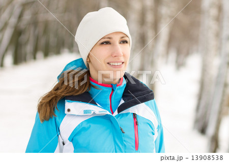 Cheerful young sport woman at winter outdoor activity 13908538