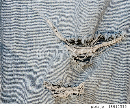 jean texture with a hole and threads showing 13912556