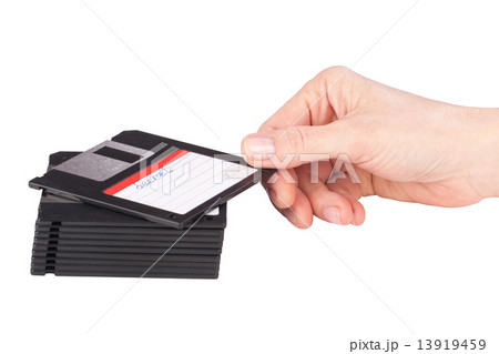 female hand takes a floppy disk 13919459