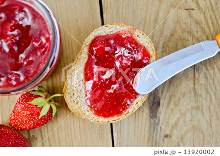 Bread with strawberry jam and berries on board 13920002
