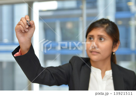 India business woman writing with pen in the air 13921511