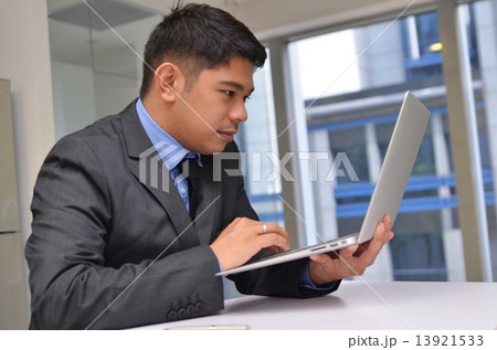 Asian business man using laptop computer in the office 13921533
