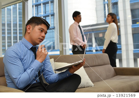 Asian business man using laptop computer in the office 13921569
