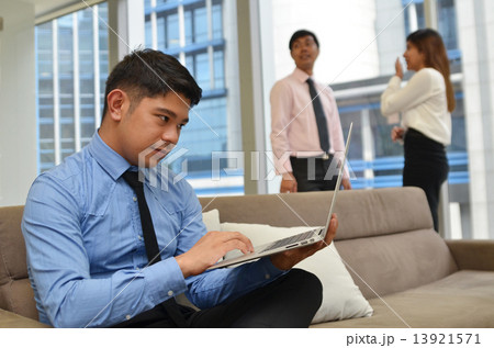 Asian business man using laptop computer in the office 13921571