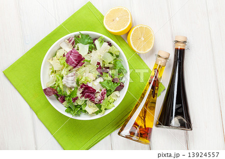 Fresh healthy salad and condiments over white wooden table Fresh healthy salad and condiments over white wooden table 13924557