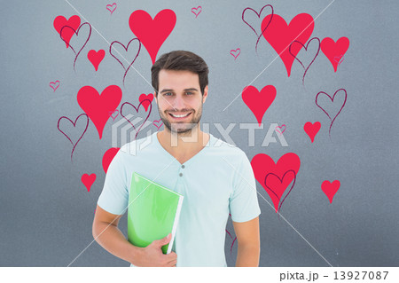 Composite image of student holding notepad Composite image of student holding notepad 13927087