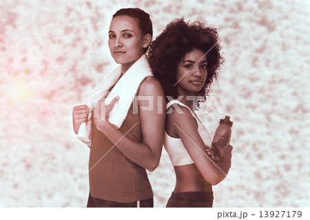 Composite image of fit women standing with waterbottle and towel Composite image of fit women standing with waterbottle and towel 13927179