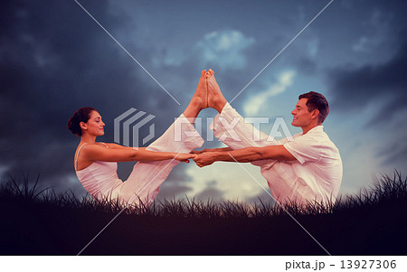 Composite image of peaceful couple sitting in boat position toge 13927306