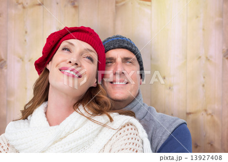 Composite image of happy couple in warm clothing Composite image of happy couple in warm clothing 13927408