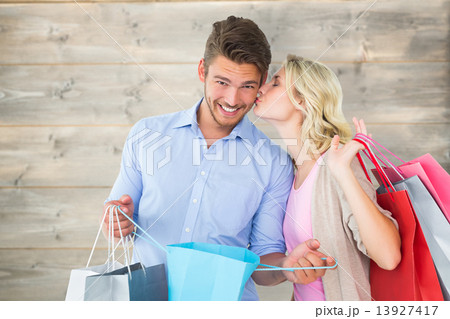 Composite image of attractive young couple holding shopping bags Composite image of attractive young couple holding shopping bags 13927417
