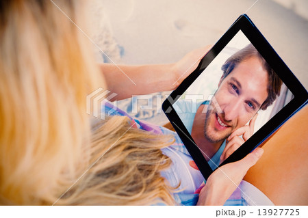 Composite image of handsome smiling man sitting on bed looking a Composite image of handsome smiling man sitting on bed looking a 13927725