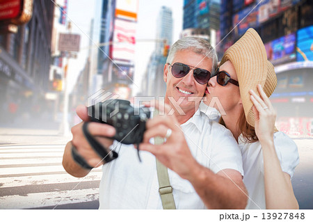 Composite image of vacationing couple taking photo 13927848