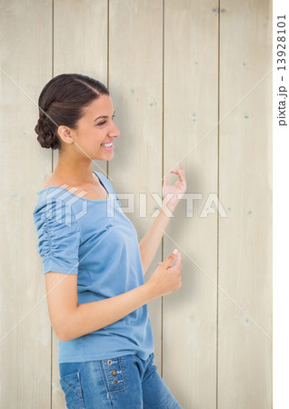 Composite image of pretty brunette playing air guitar 13928101