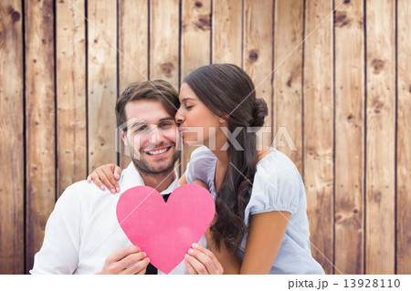 Composite image of pretty brunette giving boyfriend a kiss and h Composite image of pretty brunette giving boyfriend a kiss and h 13928110