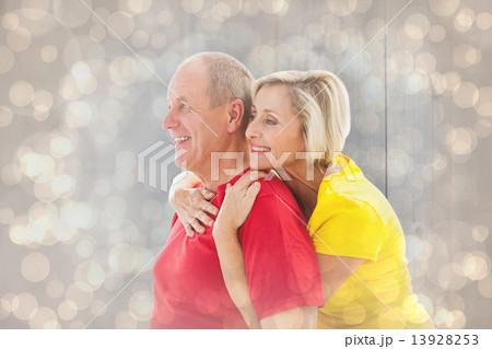 Composite image of happy mature couple hugging and smiling Composite image of happy mature couple hugging and smiling 13928253