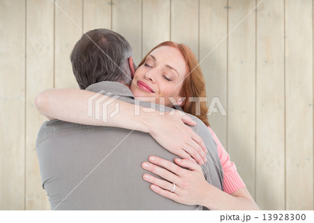 Composite image of casual couple hugging each other Composite image of casual couple hugging each other 13928300