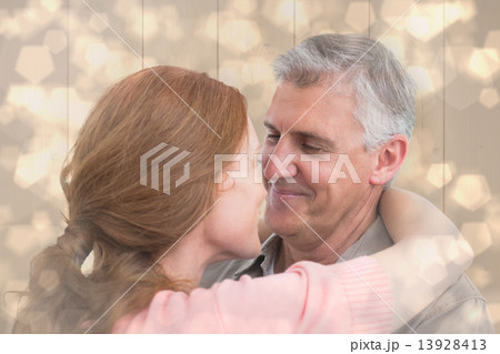 Composite image of casual couple hugging and smiling Composite image of casual couple hugging and smiling 13928413