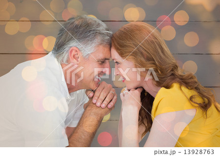 Composite image of casual couple smiling at each other Composite image of casual couple smiling at each other 13928763
