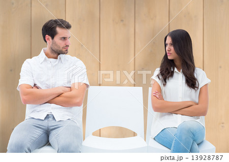 Composite image of angry couple not talking after argument 13928787