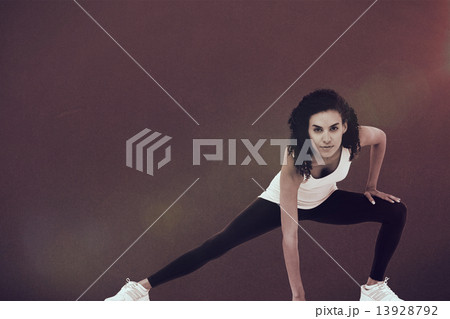 Composite image of fit woman stretching her legs 13928792