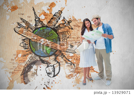Composite image of happy hipster couple looking at map 13929071