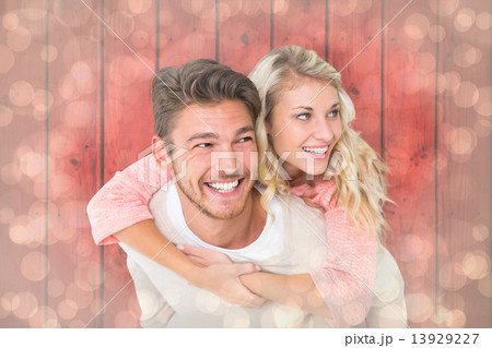 Composite image of handsome man giving piggy back to his girlfri Composite image of handsome man giving piggy back to his girlfri 13929227