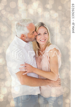 Composite image of affectionate man kissing his wife on the chee 13929229