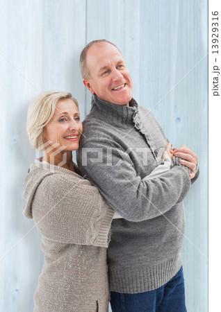 Composite image of happy mature couple in winter clothes Composite image of happy mature couple in winter clothes 13929316