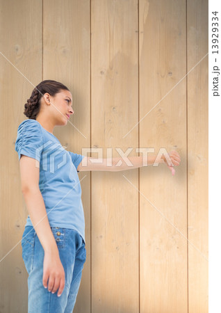 Composite image of pretty brunette giving thumbs down Composite image of pretty brunette giving thumbs down 13929334