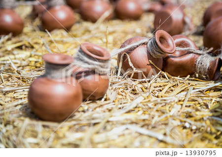Small ceramic crocks or pot on straw 13930795