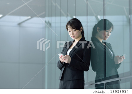 One young successful Chinese businesswoman using smart phone  13933954