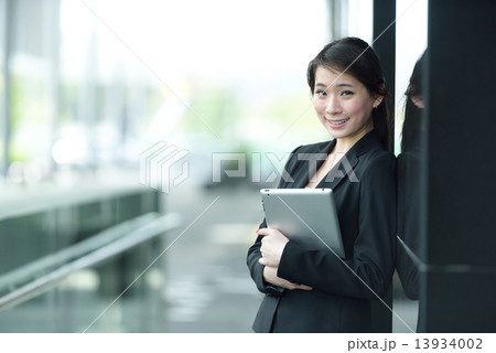 One young successful Chinese businesswoman holding tablet iPad 13934002