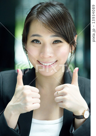 One young successful Chinese businesswoman giving 2 thumbs up 13934089