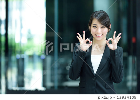 One young successful Chinese businesswoman giving ok sign 13934109