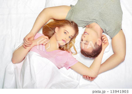 Beautiful young couple in bed 13941903