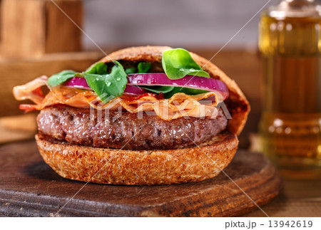 Burger close up on a cutting board on wooden background. 13942619