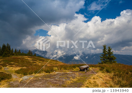 Lonely empty wood bench on the mountain 13943940