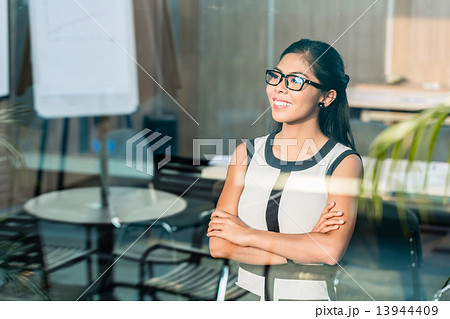 Indonesian business woman at office window 13944409