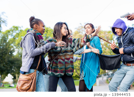 Group of girls being threatened with gun by robber 13944455