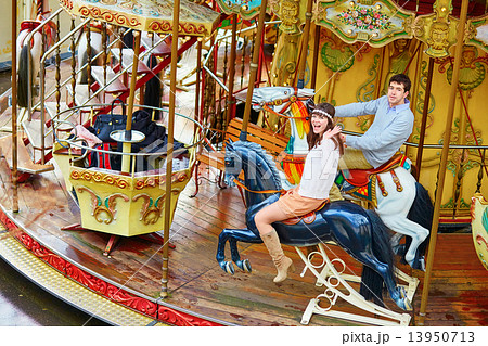 Happy couple on the merry-go-round in Paris 13950713