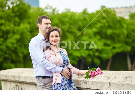 Couple with pink roses outdoors 13951380