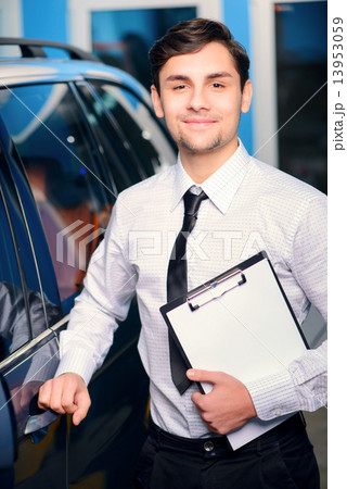 Car service manager posing with a clipboard 13953059