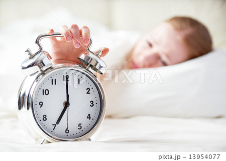 alarm clock and sleeping young woman 13954077