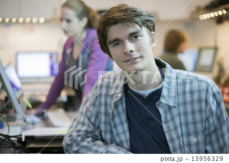 Two people in a computer repair shop. Technicians, young people working to repair computers. Two people in a computer repair shop. Technicians, young people working to repair computers. 13956329