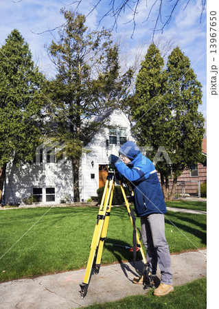 Surveyor working with theodolite Surveyor working with theodolite 13967650