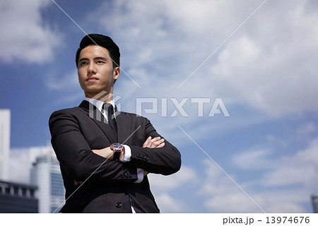 Young confident Asian young man standing proudly Young confident Asian young man standing proudly 13974676